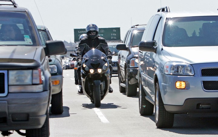 Shepler, Lori   125933.ME.0711.LANESPLIT3.ls.jpg  Shear"Ree,(front) head of Southern California Sport Bike Association, and Mark Russell,17, go between cars on the southbound 405 in Long Beach on July 10, 2007.